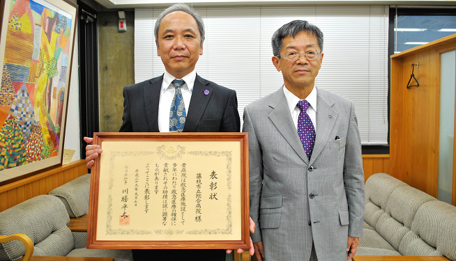 救急医療功労団体知事表彰を受賞し表彰状を持っている写真